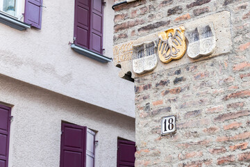 Corner of a historic house with the coat of arms and windows in Germany