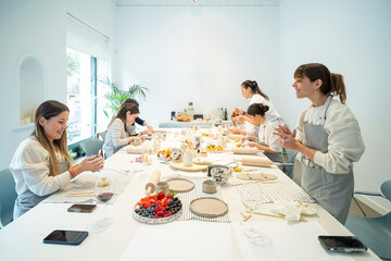 Cheerful women having pottery lesson in studio