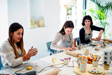 Cheerful women having pottery lesson in studio