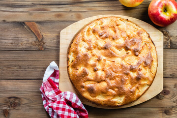 apple pie, charlotte on wooden background. Top view, copy space, flat lay.