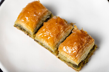 Pistachio baklava. Pistachio baklava with syrup on a dark background. Turkish cuisine delicacies. Close up