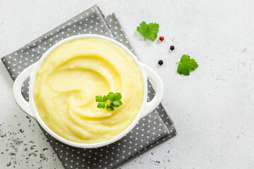 Fluffy mashed potatoes in a bowl. Top view, copy space, flat lay.