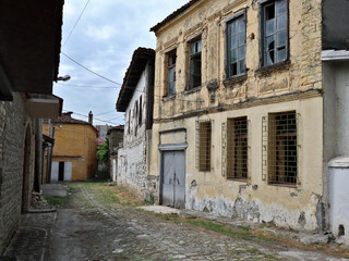 old abandoned building with broken windows in a small street in europe (old, historic) albania elbasan