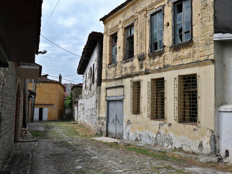 old abandoned building with broken windows in a small street in europe (old, historic) albania elbasan