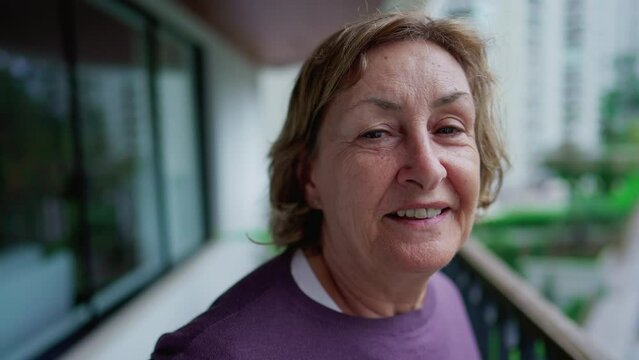 Portrait of a happy senior woman smiling at camera. One female person in 70s smiling at camera close-up face