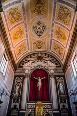 Fototapeta na wymiar Lowlight altar with saints and painted ceiling inside the Parish Church of Santo Ildefonso, Almodôvar PORTUGAL