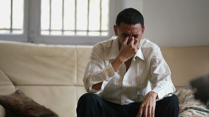 Dramatic young man feeling distraught and stressed from emotional pressure. Frustrated male person...