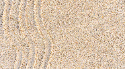 Fototapeta na wymiar Sand beach texture background with line ripple well free space for text design summer 