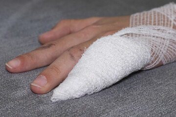 Fototapeta na wymiar Bandaged, broken ring finger of a teenage girl's hand.