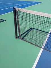 Tennis court, brightly colored and ready to play. 