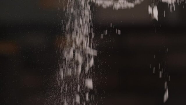 Cement mixture. A construction cement dry mix for construction work will be poured out close-up. Slow motion