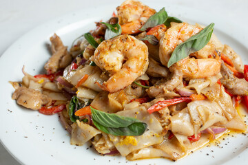 A view of a plate of drunken noodles.