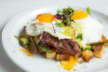 A view of a plate of steak and eggs.
