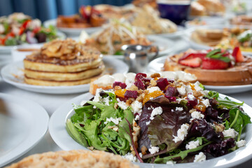 A view of a restaurant table full of assorted appetizers and entrees, as a background.
