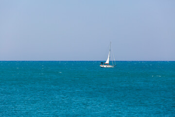 A sailboat is sailing in the ocean