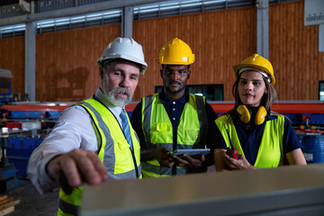 Plant manager visit engineer in factory at production line discuss on quality assurance improvement