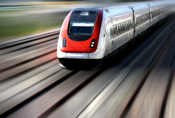 Train speeding along its tracks with motion blur.