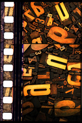 Collage of old letterpress letters and numbers and piece of 35 mm film. - obrazy, fototapety, plakaty
