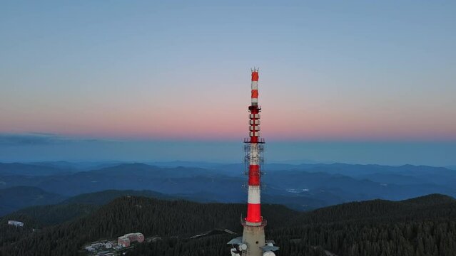 Tower Snezhana on peak of Snezhana covered with spruce forests in Rhodope mountains