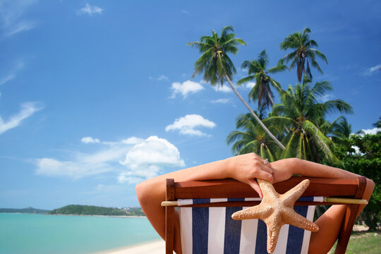 Woman in deckchair with tropical view background