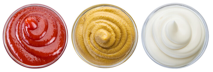 Three sauces - ketchup, mustard mayonnaise in bowls. Top view. File contains clipping path.