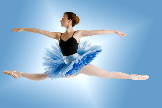 dancer in blue tutu jumpig on a shining blue background