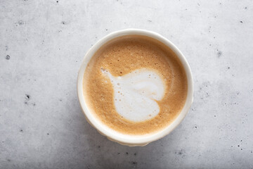 A top down view of a coffee cup with latte art.