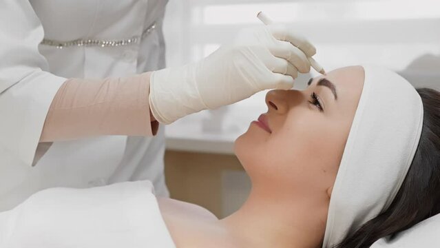 Procedure for marking and preparing for injection Botox, butolin toxin, which is carried out by professional cosmetologist in beauty salon to maintain youthful look and prevent wrinkles on woman face