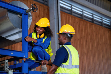Female and male engineer in factory production line discuss and repair broken machine