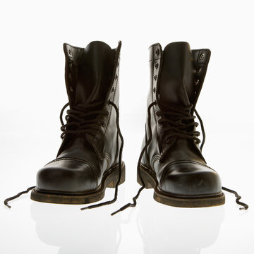Black leather high top boots with untied laces.