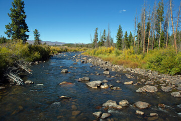 Clean, clear mountain stream with a beautiful blue sky in the background