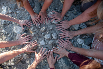 Women's hands in a circle on the earth.  - 600808793