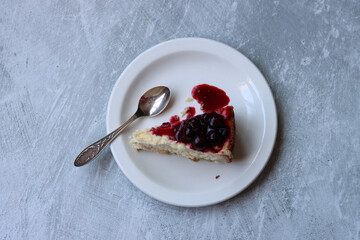 Cheesecake with cherry jam on the table. Close up photo of sweet cake