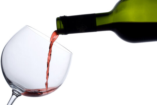 Wine bottle and a wine glass against white background