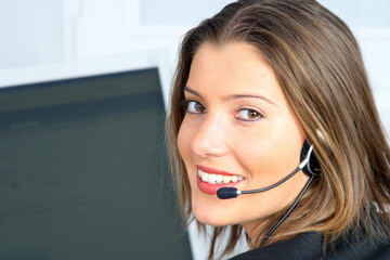 young woman on customer service with computer in background