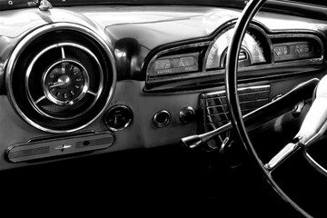 Obraz premium View of the interior of an old vintage car in black and white