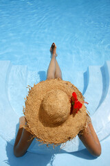 Woman lying in blue pool