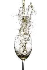 white wine being poured in to a wine glass from a height