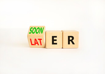 Sooner or later symbol. Businessman turns wooden cubes and changes the word Later to Sooner. Beautiful white table white background. Copy space. Business and sooner or later concept.