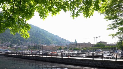 Fototapeta na wymiar Europe, Italy, Como 2023 - the lake promenade reopens after the renovation works - lake Como invaded by tourists from all over the world - sightseeing and natural and artistic beauty in Lombardy