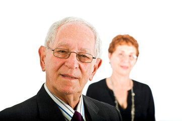 closeup  portrait off a senior businessman with colleague in the background isolated on white