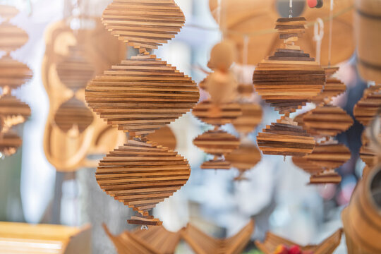 Handmade wind spinner. The wind spinner is made of strips of wood folded into a spiral, capable of spinning in the wind, designed for hanging and decoration.