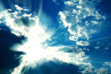 Fantastic sun rays striking through clouds like an explosion. Graphic effects are applied for a...