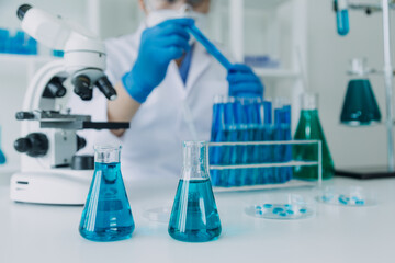 Medical Development Laboratory: Caucasian Female Scientist Looking Under Microscope, Analyzes Petri Dish Sample. Specialists Working on Medicine, Biotechnology Research in Advanced Pharma Lab
