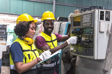 Black Engineer man and woman working together in manufacturing machinery factory