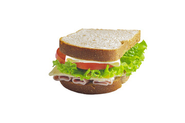 Sandwich with Ham, cheese, lettuce, and tomatoes inside of a loaf bread
