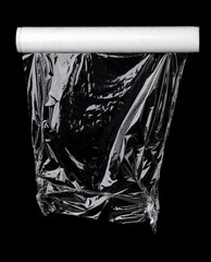 Roll of plastic wrap texture on the black background. Plastic bag texture. Reusable trash and waste.