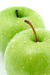 Closeup of fresh green apples with water droplets.