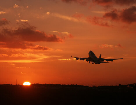 Boeing 747 Plane taking off at sunset time in The Netherlands. Typical Travel picture.