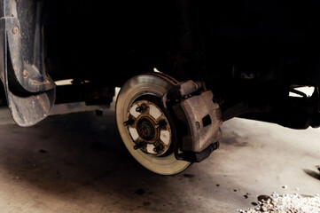 old braking system. close-up of repair. replacement brake disc and pad. car maintenance service. car repairs